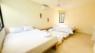 a room with two beds and two windows at Cabaña Tierramia 2 in San Silvestre