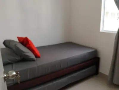 a bed with two pillows on it in a room at Great and affordable in Cartagena de Indias