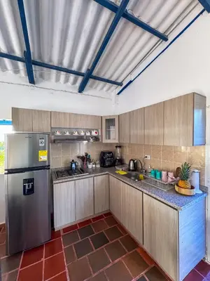 a kitchen with a stainless steel refrigerator and cabinets at Liz&Mar in El Morro