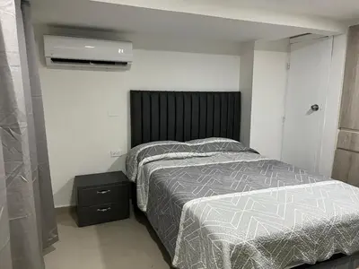 a bedroom with a bed and a air conditioner at Aparta estudio confortable y completo in Barranquilla