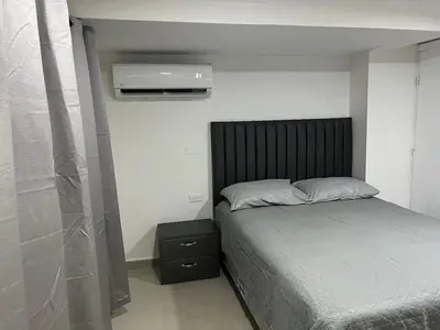 a bedroom with a bed and a air conditioner at Aparta estudio confortable y completo in Barranquilla