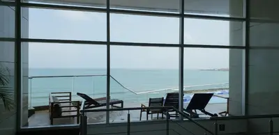 a room with a large window looking out at the ocean at Palmetto Eliptic Bahia in Cartagena de Indias