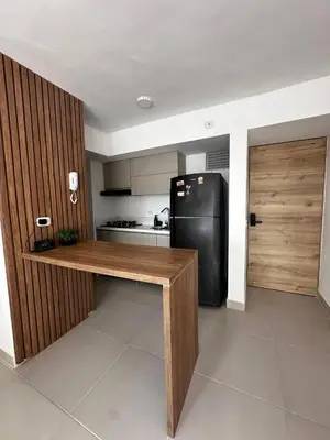 a kitchen with a black refrigerator and a wooden counter at Apartamento Económico en Cartagena in Cartagena de Indias