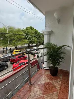a balcony with a view of a parking lot with cars at Hotel San Francisco Inn in Barranquilla