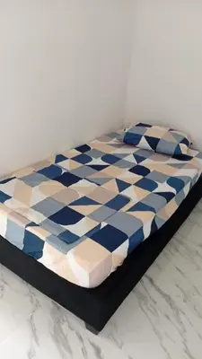 a bed in a room with a blue and white at Edificio Lotus Torices Cartagena in Cartagena de Indias