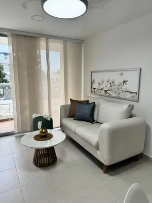 a living room with a couch and a table at Baluarte de caribe 212 in Cartagena de Indias