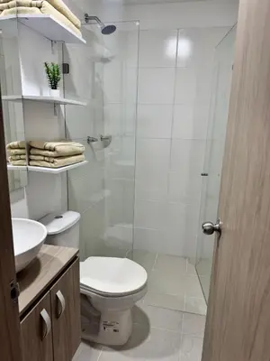 a bathroom with a toilet and a glass shower at Baluarte de caribe 212 in Cartagena de Indias
