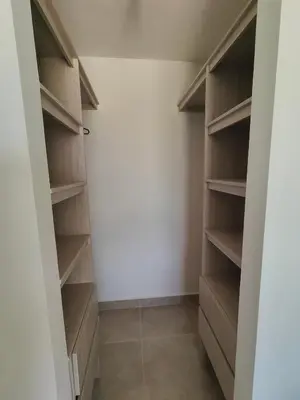 a walk in closet with wooden shelves and a tile floor at Encantador Apartamento en Serena del Mar in Manzanillo del Mar