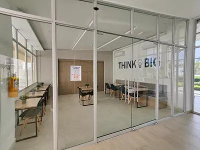 an office with glass walls and tables and chairs at Encantador Apartamento en Serena del Mar in Manzanillo del Mar