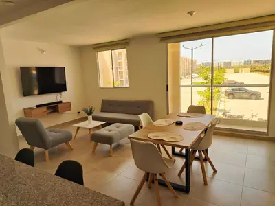 a living room with a table and a couch at Encantador Apartamento en Serena del Mar in Manzanillo del Mar