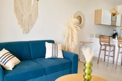a living room with a blue couch and a table at Lujo y comodidad en Baia Kristal, Cartagena in Cartagena de Indias