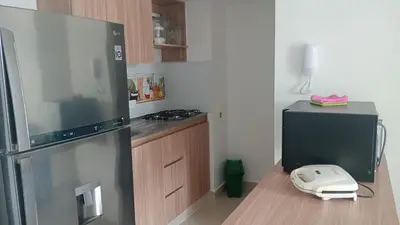 a kitchen with a refrigerator and a phone on a counter at APTO A 5 MIN CAMINANDO PLAYAS DE MARBELLA y A 20 MIN DE MURALLAS in Cartagena de Indias