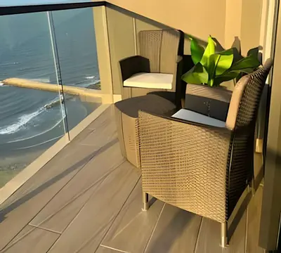 a balcony with a wicker chair and a plant at Spectacular apartment, unparallel views! in Cartagena de Indias