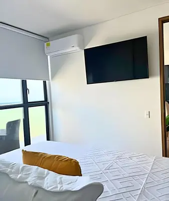 a bedroom with a bed with a flat screen tv on the wall at Spectacular apartment, unparallel views! in Cartagena de Indias