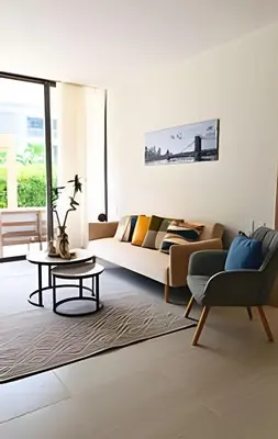 a living room with a couch and a table at Exclusivo Apto, Piscina Privada y Salida a playa in Cartagena de Indias