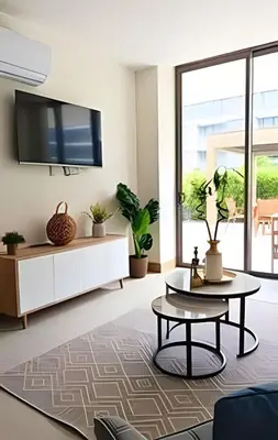a living room with a tv and plants at Exclusivo Apto, Piscina Privada y Salida a playa in Cartagena de Indias