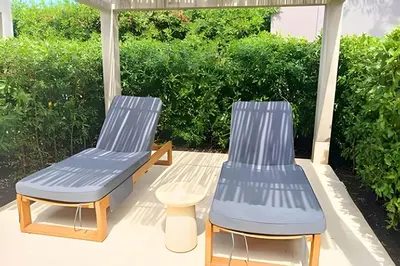 two chairs and a table on a patio at Exclusivo Apto, Piscina Privada y Salida a playa in Cartagena de Indias