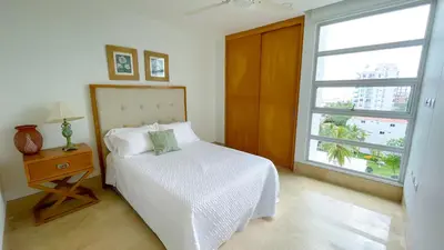 a bedroom with a bed and a large window at Magico Apartamento Frente al Mar 3 Habitaciones TR72 in Coveñas