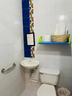 a small bathroom with a toilet and a sink at Casa Inés Tolú in Tolú
