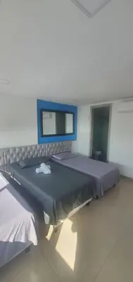 two beds in a hospital room with a window at Lodging Palmetto apto 4 Bocagrande in Cartagena de Indias
