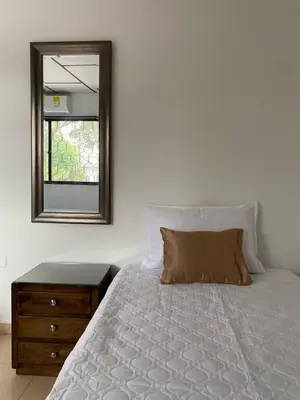 a bedroom with a bed with a mirror and a dresser at Acogedor apartamento excelente ubicación in Barranquilla