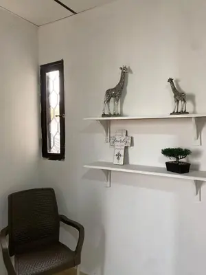a room with white shelves with a chair and a window at Acogedor apartamento excelente ubicación in Barranquilla