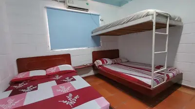 a bedroom with two bunk beds and a window at Monkey man, Beach House in Santa Marta