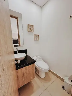 a white bathroom with a toilet and a sink at Apartamento con hermosa vista en Bocagrande in Cartagena de Indias