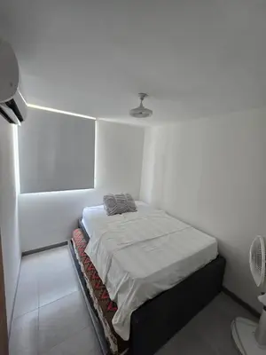 a small white room with a bed in it at brisa y sol - sunset 47 in Cartagena de Indias