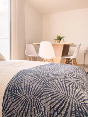 a bedroom with a bed and a table and chairs at 3 Cuartos 2 balcones in Cartagena de Indias