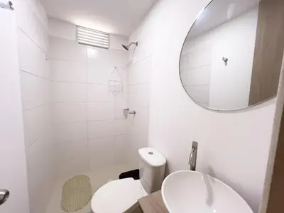 a white bathroom with a sink and a mirror at 3 Cuartos 2 balcones in Cartagena de Indias
