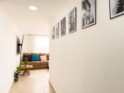 a living room with a couch and pictures on the wall at 3 Cuartos 2 balcones in Cartagena de Indias