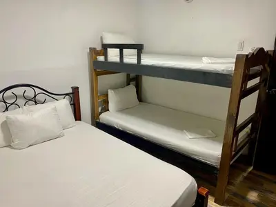 two bunk beds are in a room withthritisthritisthritisthritisthritisthritisthritisthritis at Hotel Casa Lopez - Cartagena in Cartagena de Indias