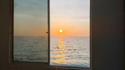 a window view of the ocean with the sunset at Renacer ancestral Barú in Playa Blanca