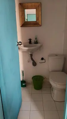 a bathroom with a sink and a toilet at Renacer ancestral Barú in Playa Blanca