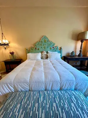 a bed with a teddy bear sitting on top of it at Apto cuesta 203 in Cartagena de Indias