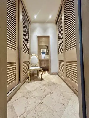 a hallway with a chair in a room with windows at Apto cuesta 203 in Cartagena de Indias
