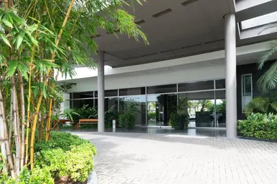 an office building with glass doors and palm trees at The Beaches-Beachfront Retreat in Cartagena de Indias