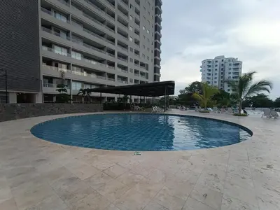 a large swimming pool in front of a building at Apartamento Santa Marta Sector Don Jaca in Simón Bolivar