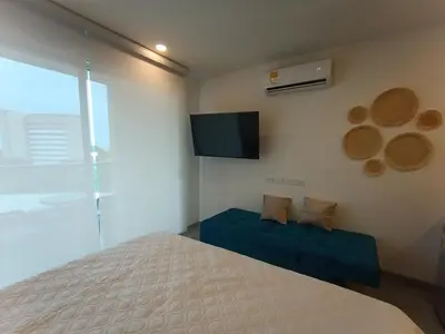 a bedroom with a bed and a flat screen tv at Apartamento Santa Marta Sector Don Jaca in Simón Bolivar