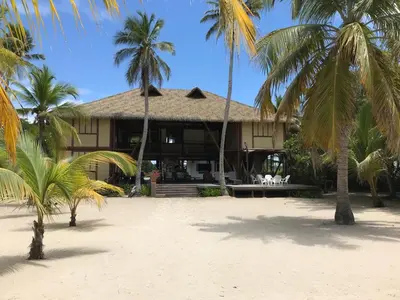 a house on the beach with palm trees at Beach House la Tortuga, Punta Seca, Rincón del Mar