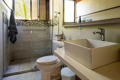 a bathroom with a sink and a toilet and a shower at Beach House la Tortuga, Punta Seca, Rincón del Mar