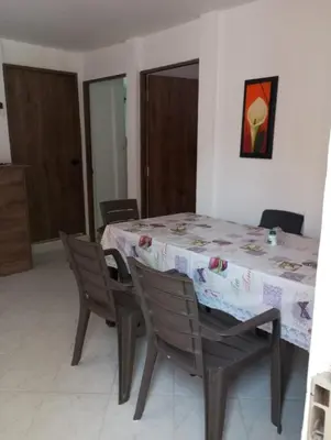 a dining room with a table with chairs and a tablecloth at Cabaña el cielo in Lorica
