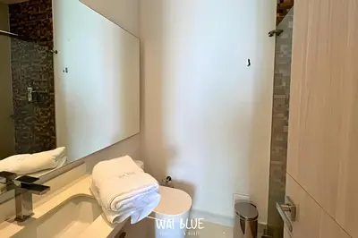 a bathroom with a sink and a toilet and a mirror at Wai Blue/Luxury Beachfront/ Bello Horizonte/ TTO03 in Playa Dormida
