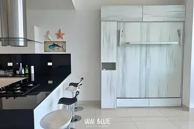 a white kitchen with a sink and a counter at Wai Blue/Luxury Beachfront/ Bello Horizonte/ TTO03 in Playa Dormida