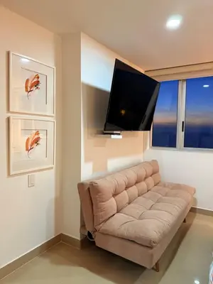 a living room with a couch and a flat screen tv at Piso 30 vista al mar, Palmetto 1 Bocagrande in Cartagena de Indias