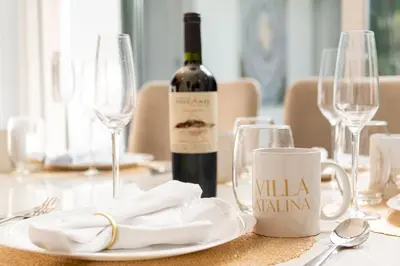 a bottle of wine sitting on a table with glasses at The Villa Catalina in Cartagena de Indias