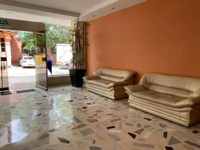 a lobby with two leather couches in a room at Hotel San Francisco in Barranquilla