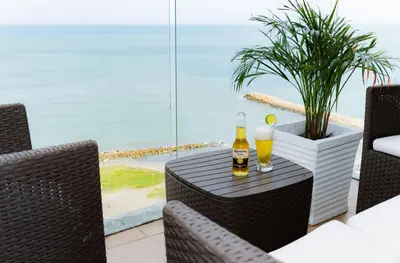 a table with two glasses of beer on a patio at Modern Sunset Stay Cartagena in Cartagena de Indias