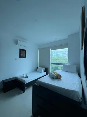 two beds in a room with blue lights at Apartamento en Cartagena a pasos de la Playa in Cartagena de Indias